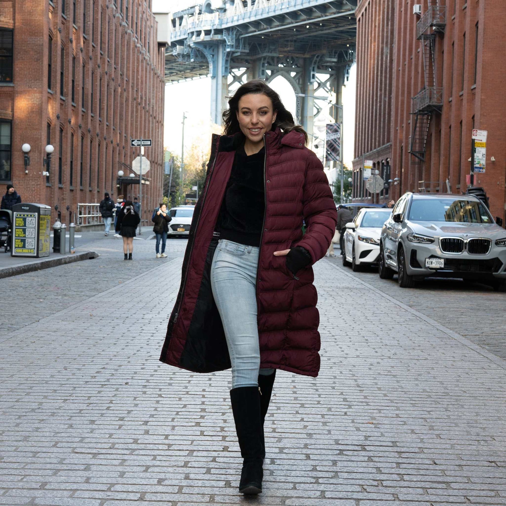 Woman wearing a warm vegan winter coat walking on a city street.